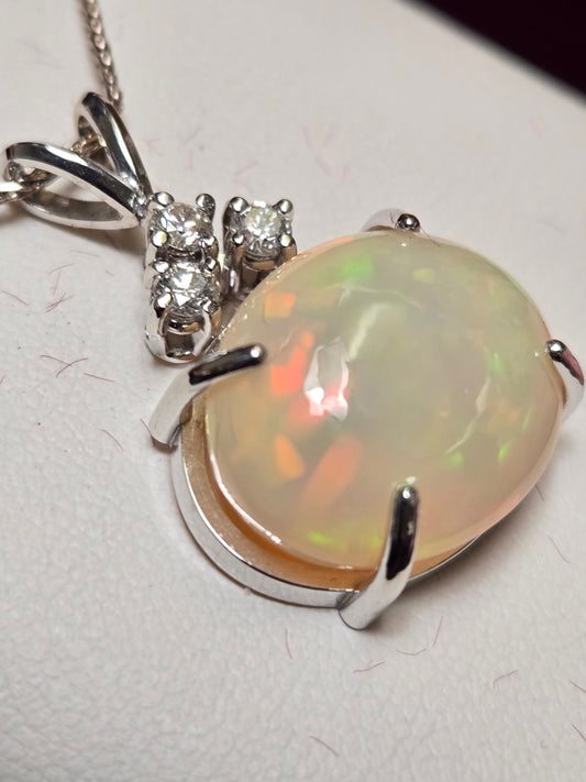 14K white gold pendant featuring a 10.5ct oval opal gemstone with intricate setting, weight 5.1 grams, from Chique Jewelry.