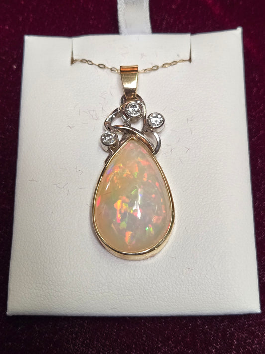14K multi-tone gold pendant featuring a 17.3ct pear-shaped opal, crafted by Chique Jewelry with elegant design.