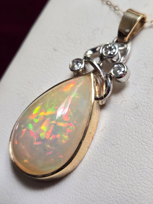 14K multi-tone gold pendant featuring a 17.3ct pear-shaped opal, crafted by Chique Jewelry, with a sleek, elegant design.
