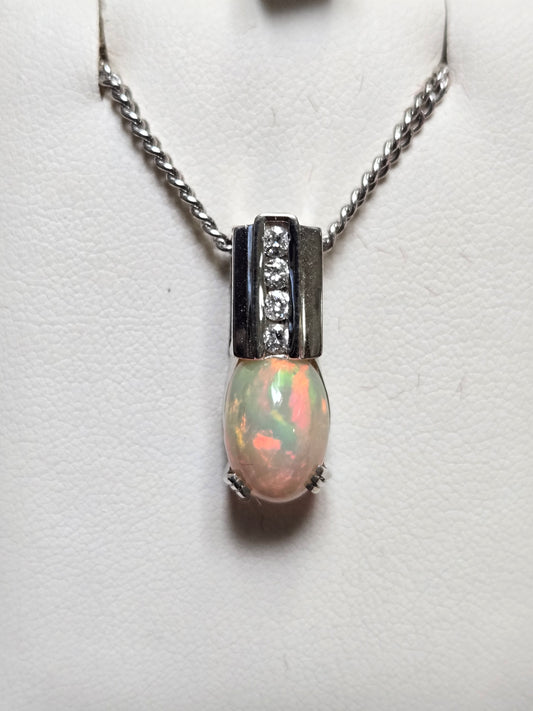 14K white gold pendant featuring a vibrant oval opal gemstone, crafted by Chique Jewelry.