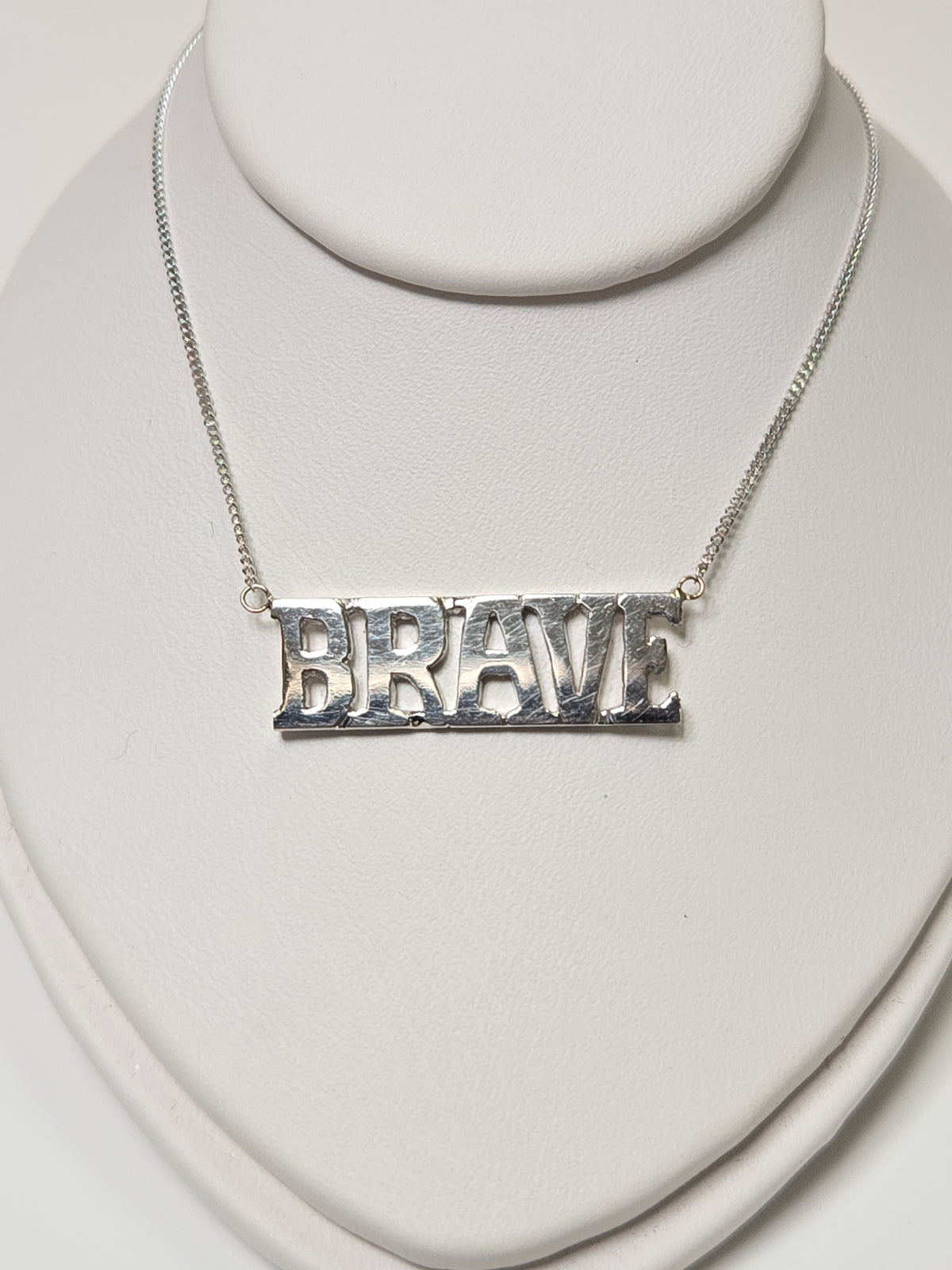 14K white gold diamond cut curb chain necklace with "Brave" pendant, 19 inches long, 3.2 grams from Chique Jewelry.