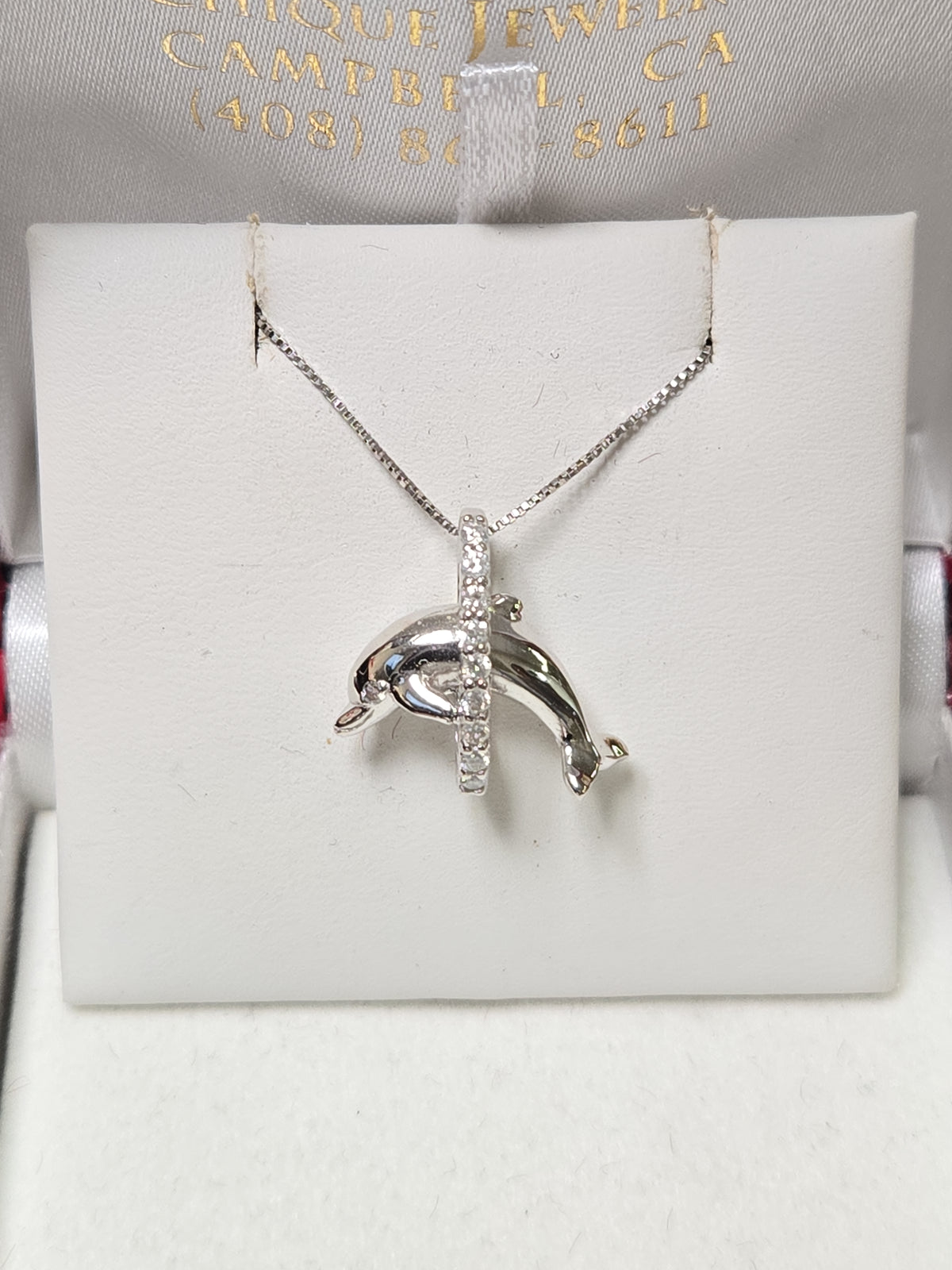 14K white gold dolphin pendant with 0.18ct round diamonds, weighing 2.4g, from Chique Jewelry.