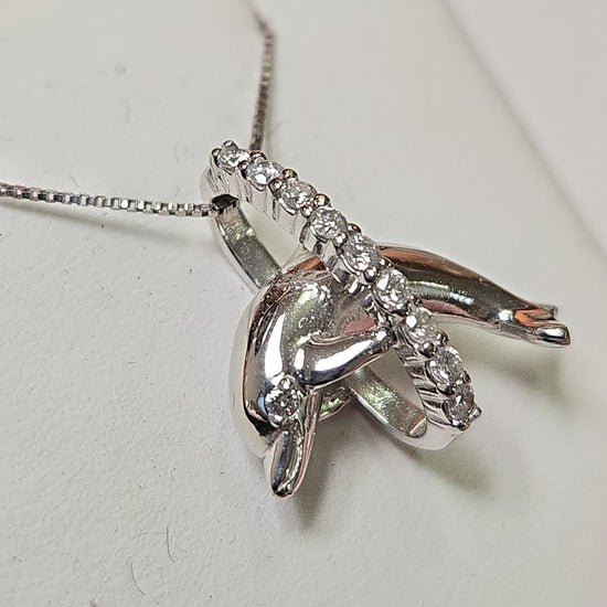 14K white gold dolphin pendant with 0.18ct round diamonds, weighing 2.4g, from Chique Jewelry.
