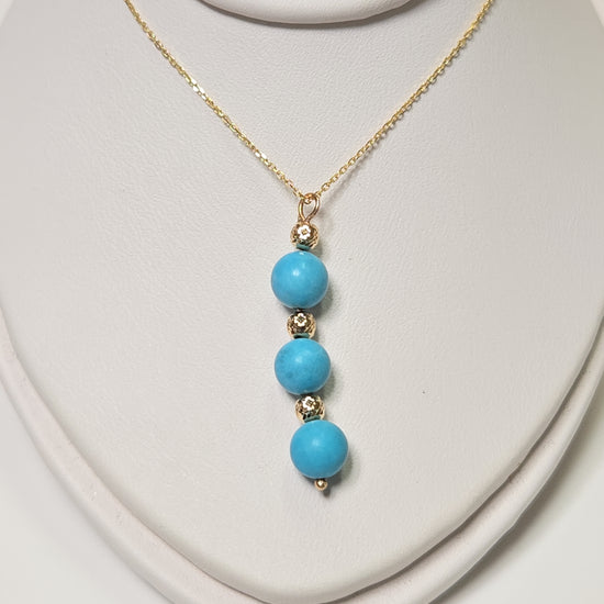 14K gold pendant necklace featuring a round turquoise stone from Chique Jewelry, weighing 1.6 grams.