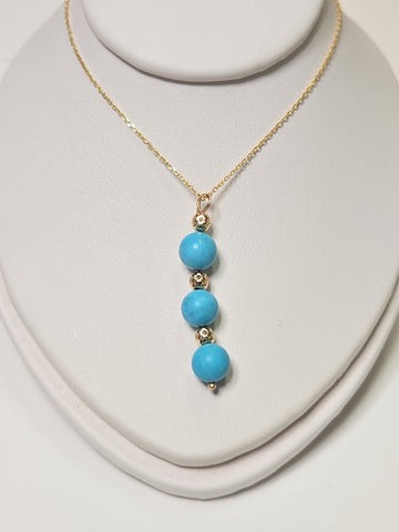 14K gold pendant necklace featuring a round turquoise stone from Chique Jewelry, weighing 1.6 grams.