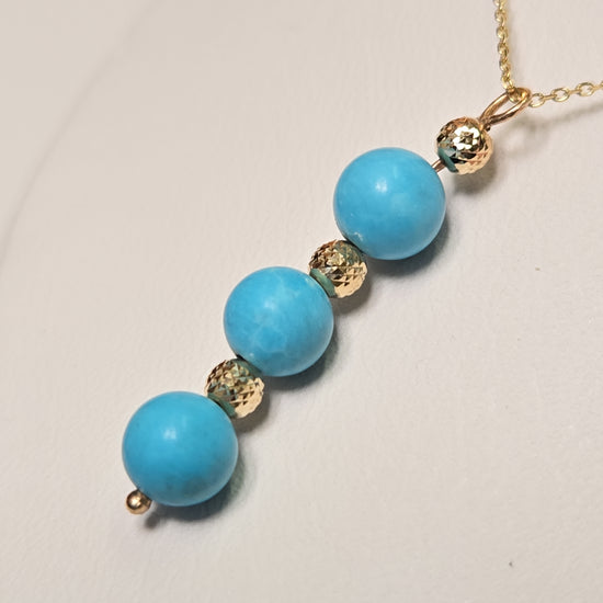 14K gold pendant necklace featuring a round turquoise stone, crafted by Chique Jewelry, weighs 1.6 grams.