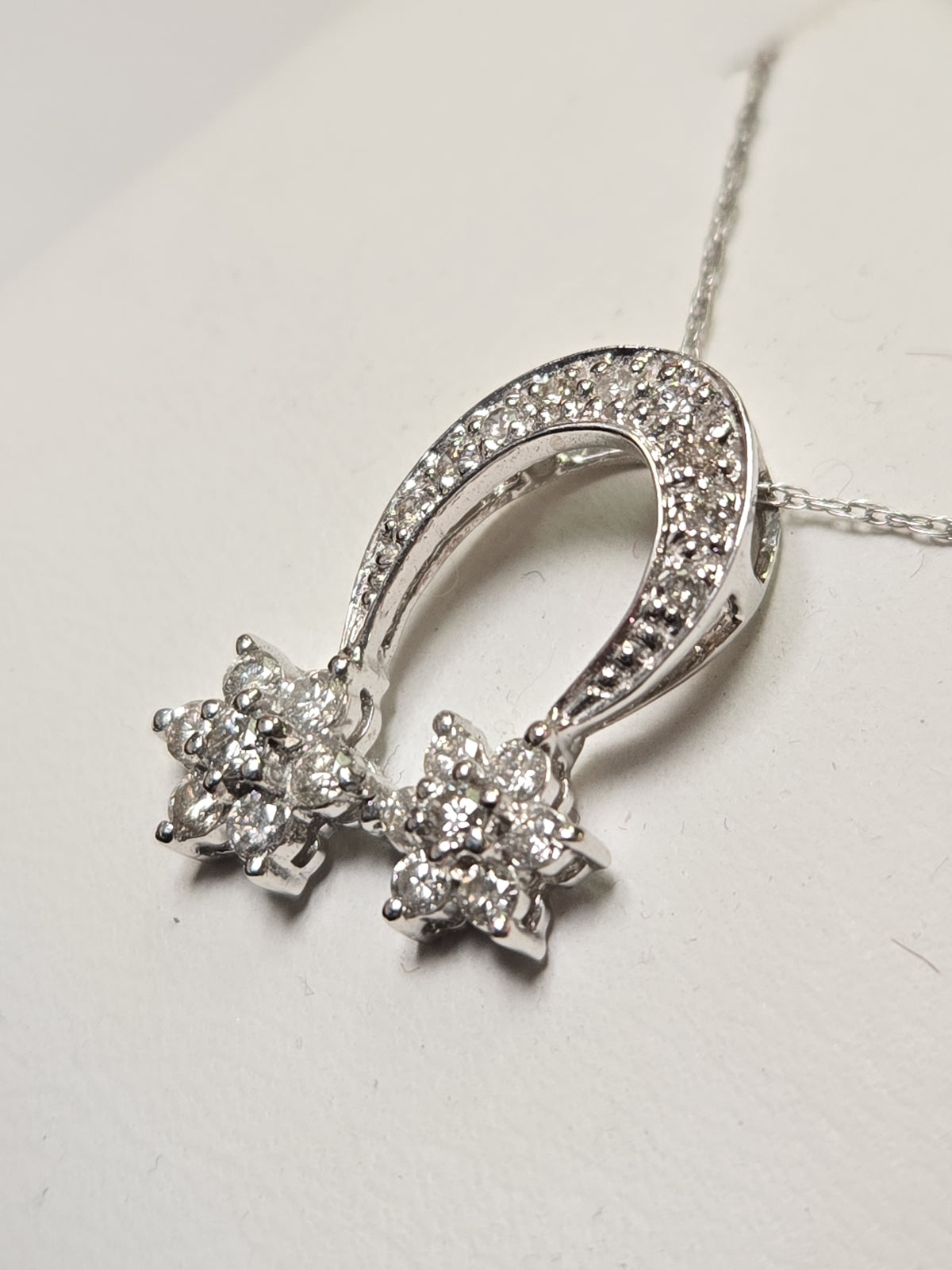 14K white gold pendant with 0.44ct round diamond, featuring elegant jewelry design, weighing 1.5 grams.