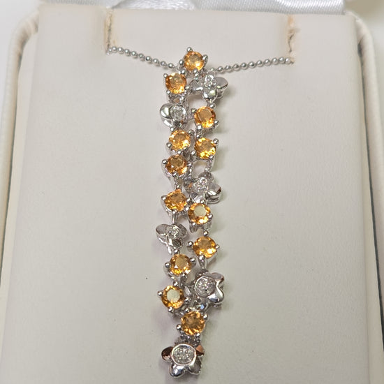 14K white gold pendant with round citrine gemstones, weighing 3.8 grams, from Chique Jewelry.