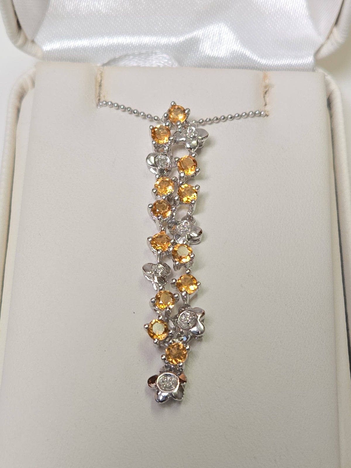 14K white gold pendant with round citrine gemstones, weighing 3.8 grams, from Chique Jewelry.