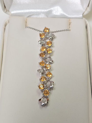 14K white gold pendant with round citrine gemstones, weighing 3.8 grams, from Chique Jewelry.