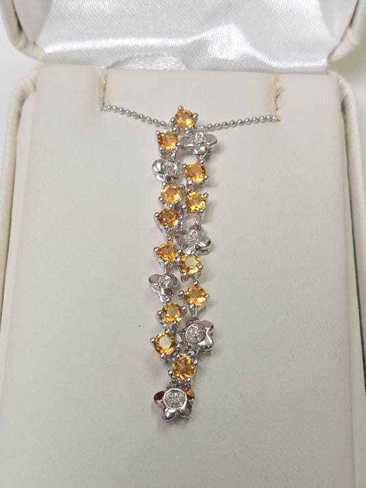 14K white gold pendant with round citrine gemstones, weighing 3.8 grams, from Chique Jewelry.