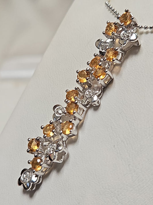 14K white gold pendant featuring round citrine gemstones, weighing 3.8 grams, from Chique Jewelry.
