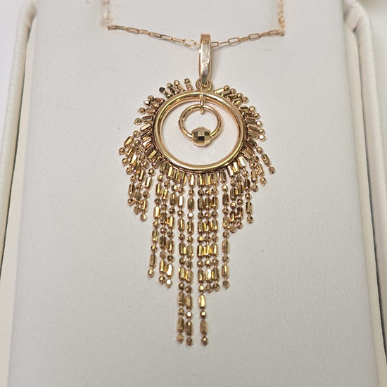 18K gold tassel pendant from Chique Jewelry, weighing 2.1g, featuring a delicate hanging design with intricate detailing.