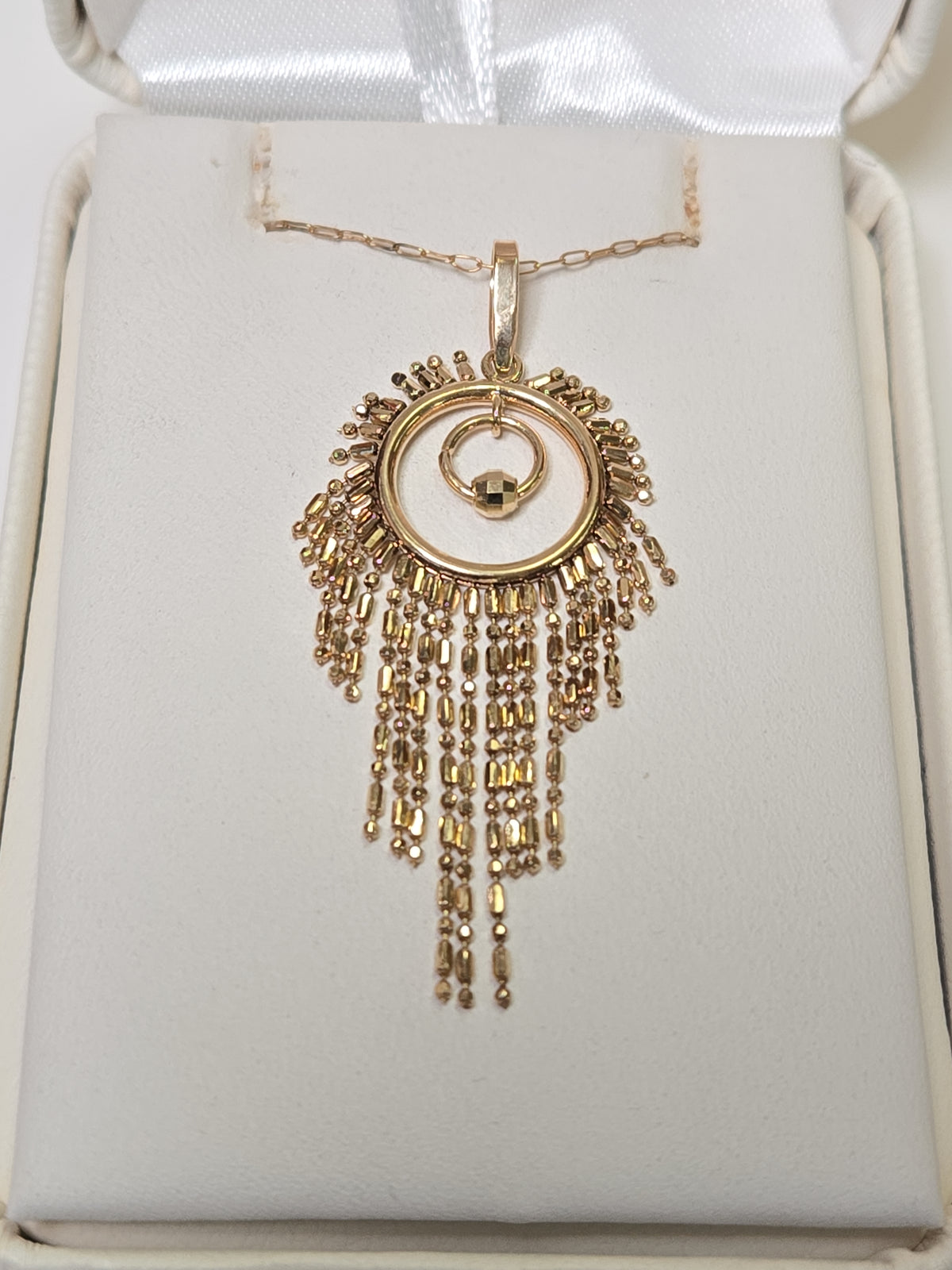 18K gold tassel pendant from Chique Jewelry, weighing 2.1g, featuring a delicate hanging design with intricate detailing.