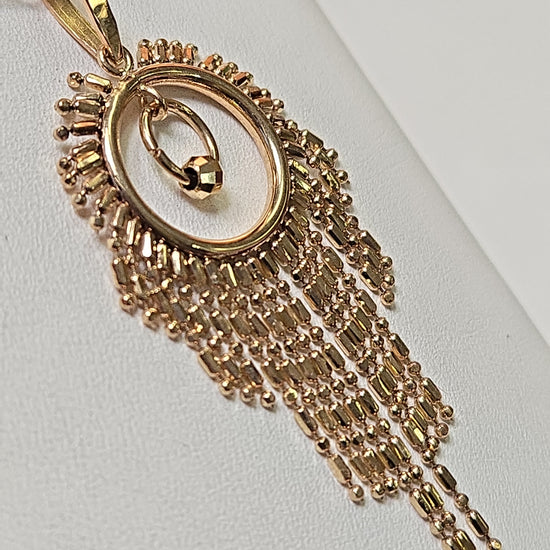 18K gold tassel pendant from Chique Jewelry, showcasing a delicate design weighing 2.1 grams.
