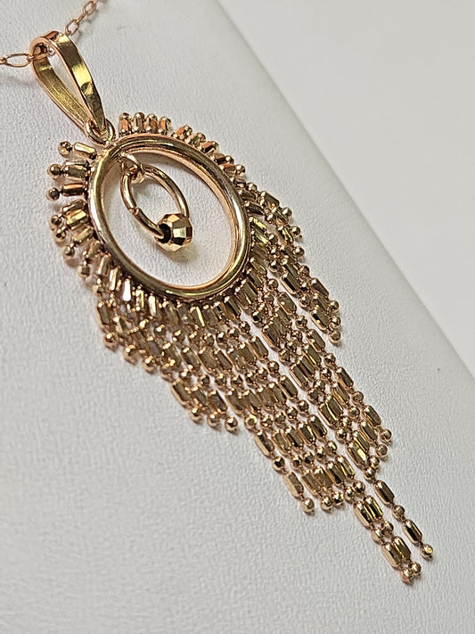 18K gold tassel pendant from Chique Jewelry, showcasing a delicate design weighing 2.1 grams.