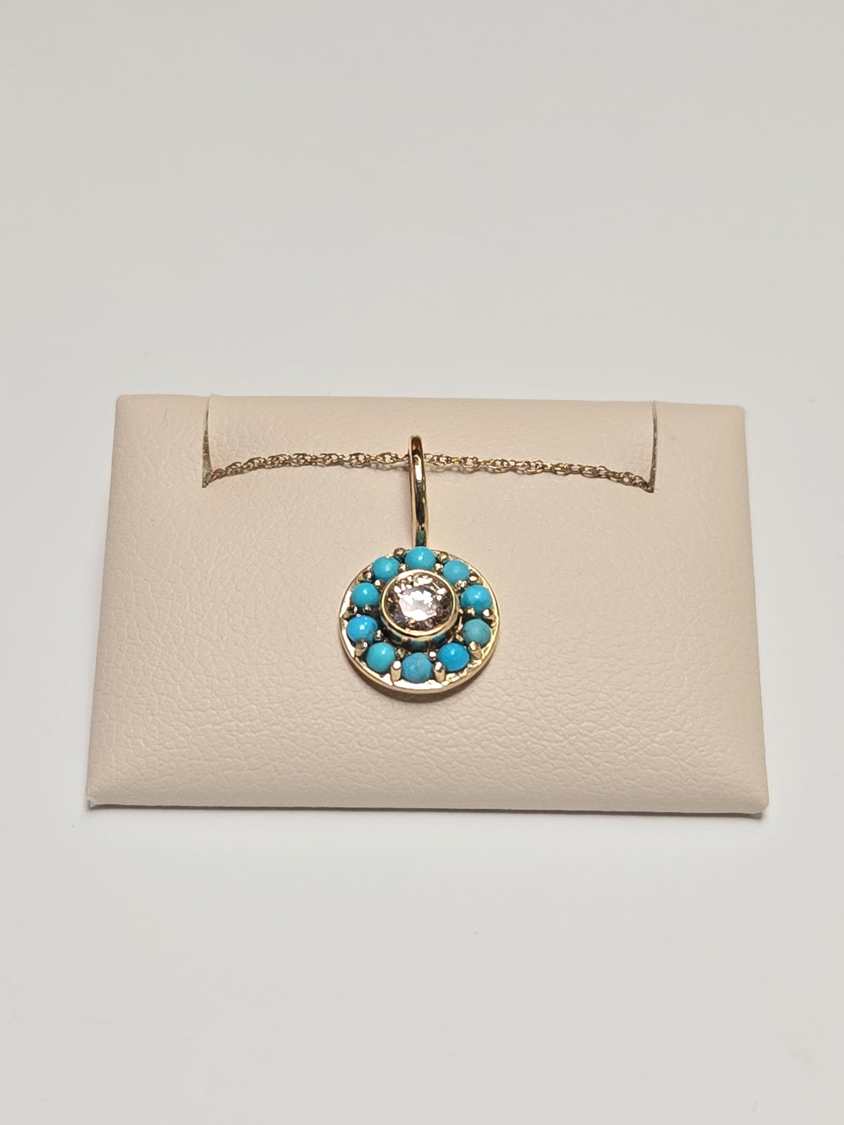14K gold pendant with round simulated diamond, weighing 1.2g, featuring a sparkling jewelry design by Chique Jewelry.