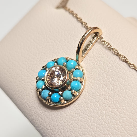 14K gold pendant with round simulated diamond, Chique Jewelry, showcasing a sparkling gemstone and elegant gold setting.