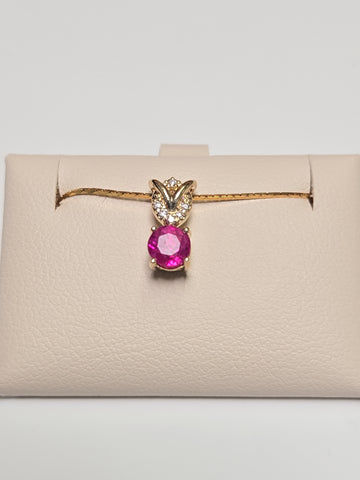14K gold pendant featuring a 0.67ct round ruby, weighing 0.8g, from Chique Jewelry.