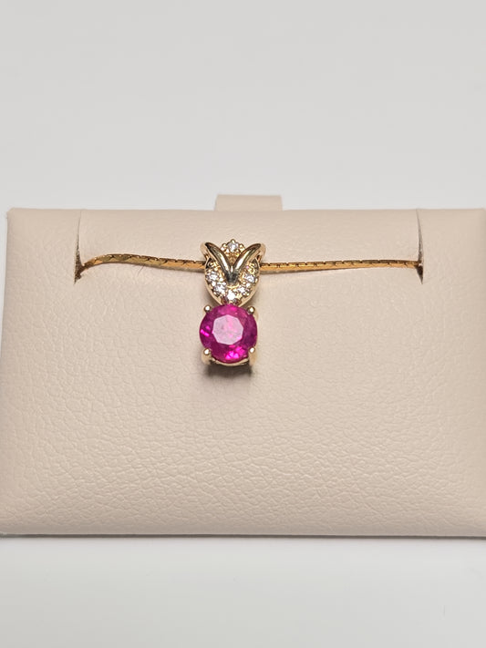 14K gold pendant featuring a 0.67ct round ruby, weighing 0.8g, from Chique Jewelry.