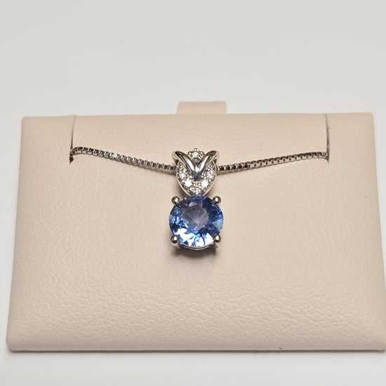 14K white gold pendant featuring a 0.72ct round sapphire, from Chique Jewelry, with a delicate and elegant design.