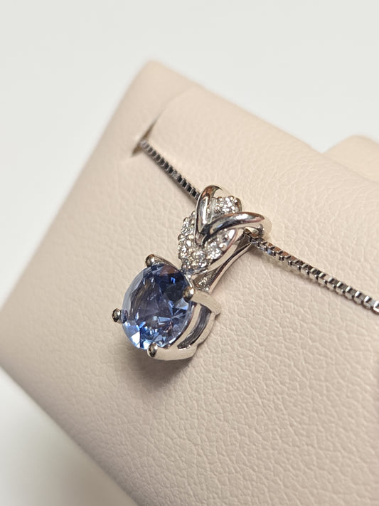 14K white gold pendant featuring a 0.72ct round sapphire, from Chique Jewelry, showcasing the elegant jewelry design.