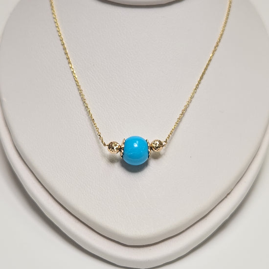 14K gold pendant necklace with round turquoise gemstone, handcrafted by Chique Jewelry, weighs 1.6 grams.