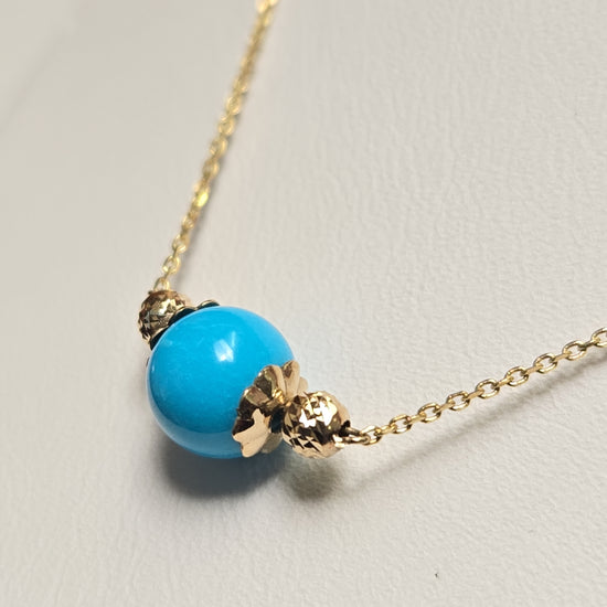 14K gold pendant necklace with round turquoise gemstone, featuring a delicate Chique Jewelry design.