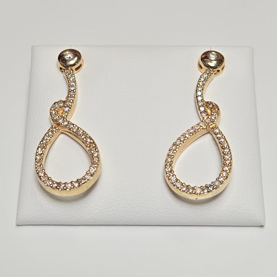 14K gold drop earrings with 1.1ct round diamonds, featuring elegant design and 7.6g weight by Chique Jewelry.