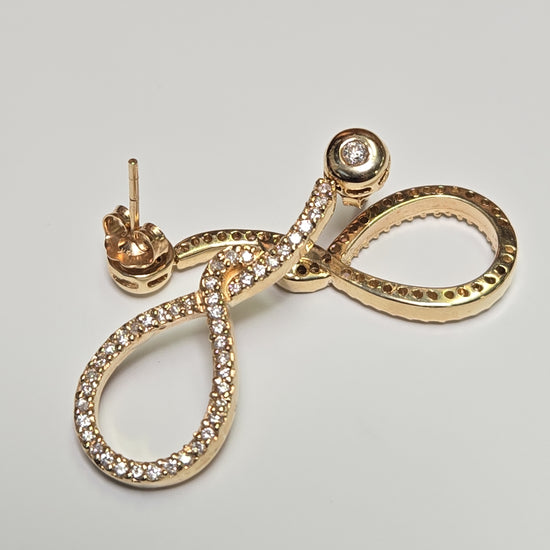 14K gold drop earrings with 1.1ct round diamonds from Chique Jewelry, featuring elegant design and sparkling gemstone details.