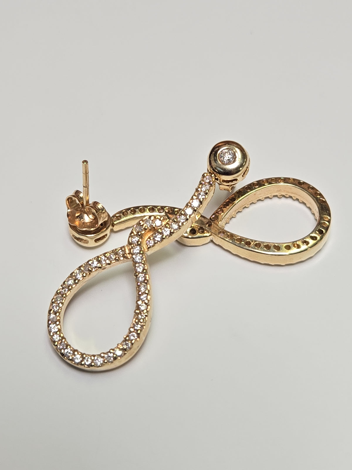 14K gold drop earrings with 1.1ct round diamonds from Chique Jewelry, featuring elegant design and sparkling gemstone details.