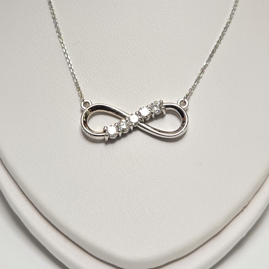 14K white gold infinity pendant necklace with lab-created diamonds, weighing 2.9g, showcasing elegant jewelry design.
