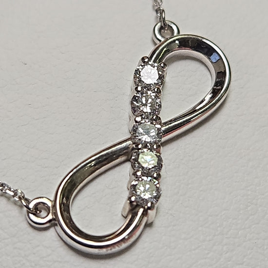 14K white gold infinity pendant necklace with lab-created diamonds, weighing 2.9g, from Chique Jewelry.