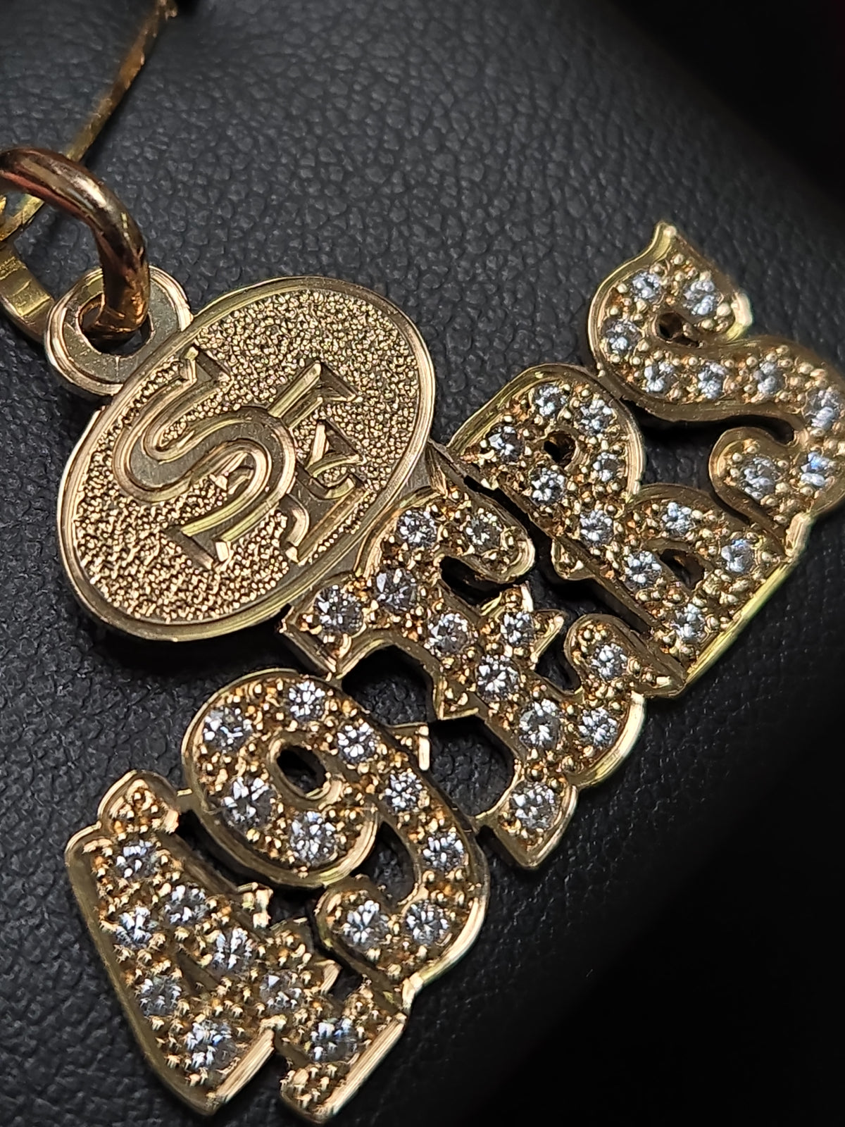 14K gold 49ers pendant with 1.1ct round diamond, crafted by Chique Jewelry, featuring a detailed sports team design.