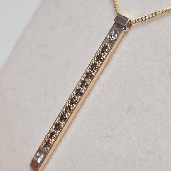 14K gold pendant featuring a 0.16ct round treated orange diamond, crafted by Chique Jewelry with a delicate design.