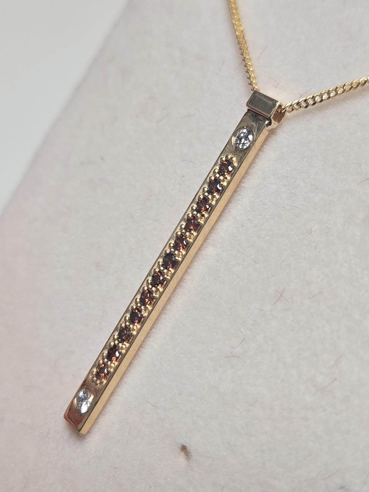 14K gold pendant featuring a 0.16ct round treated orange diamond, crafted by Chique Jewelry with a delicate design.