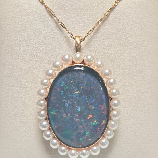 18K gold brooch pendant with oval doublette opal, crafted by Chique Jewelry, featuring a polished gold setting and elegant design.