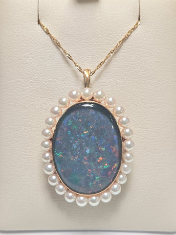 18K gold brooch pendant with oval doublette opal, crafted by Chique Jewelry, featuring a polished gold setting and elegant design.