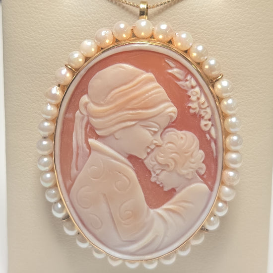 Elegant 18K gold cameo pendant with pearls by Chique Jewelry, featuring intricate carved design and a polished finish.