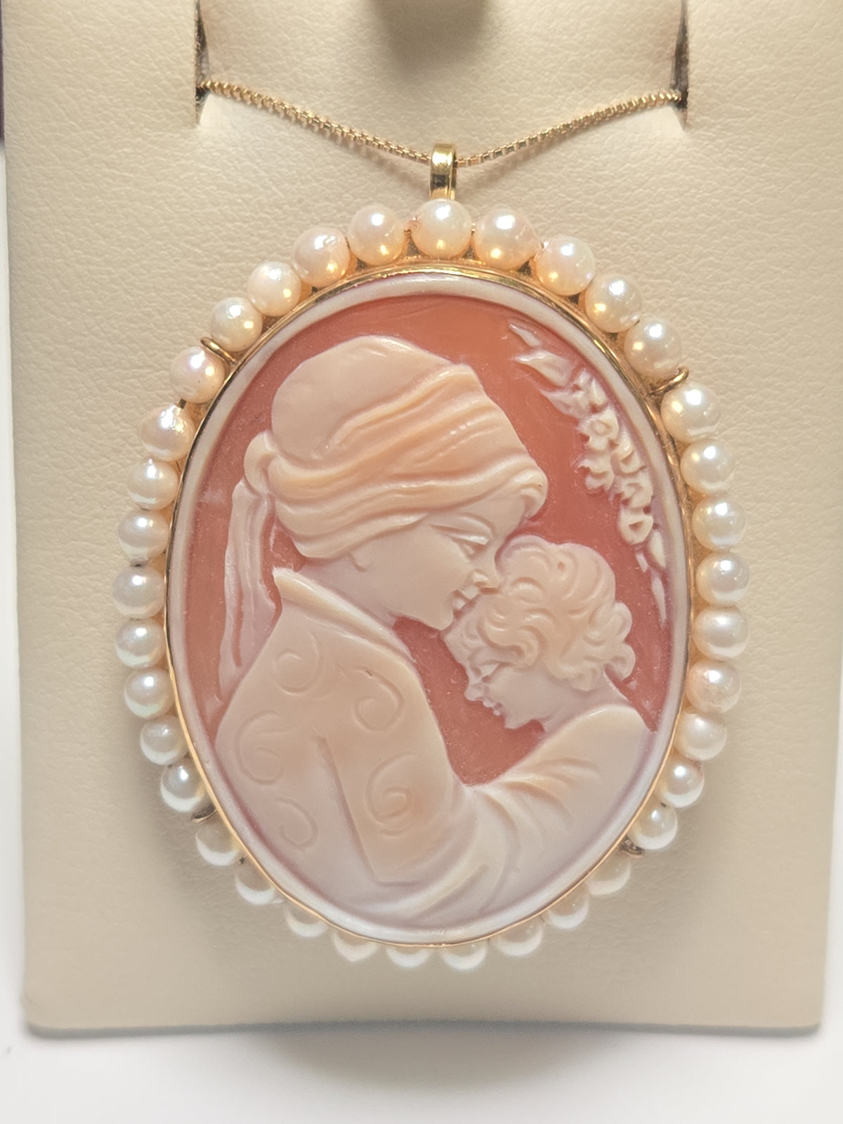 Elegant 18K gold cameo pendant with pearls by Chique Jewelry, featuring intricate carved design and a polished finish.