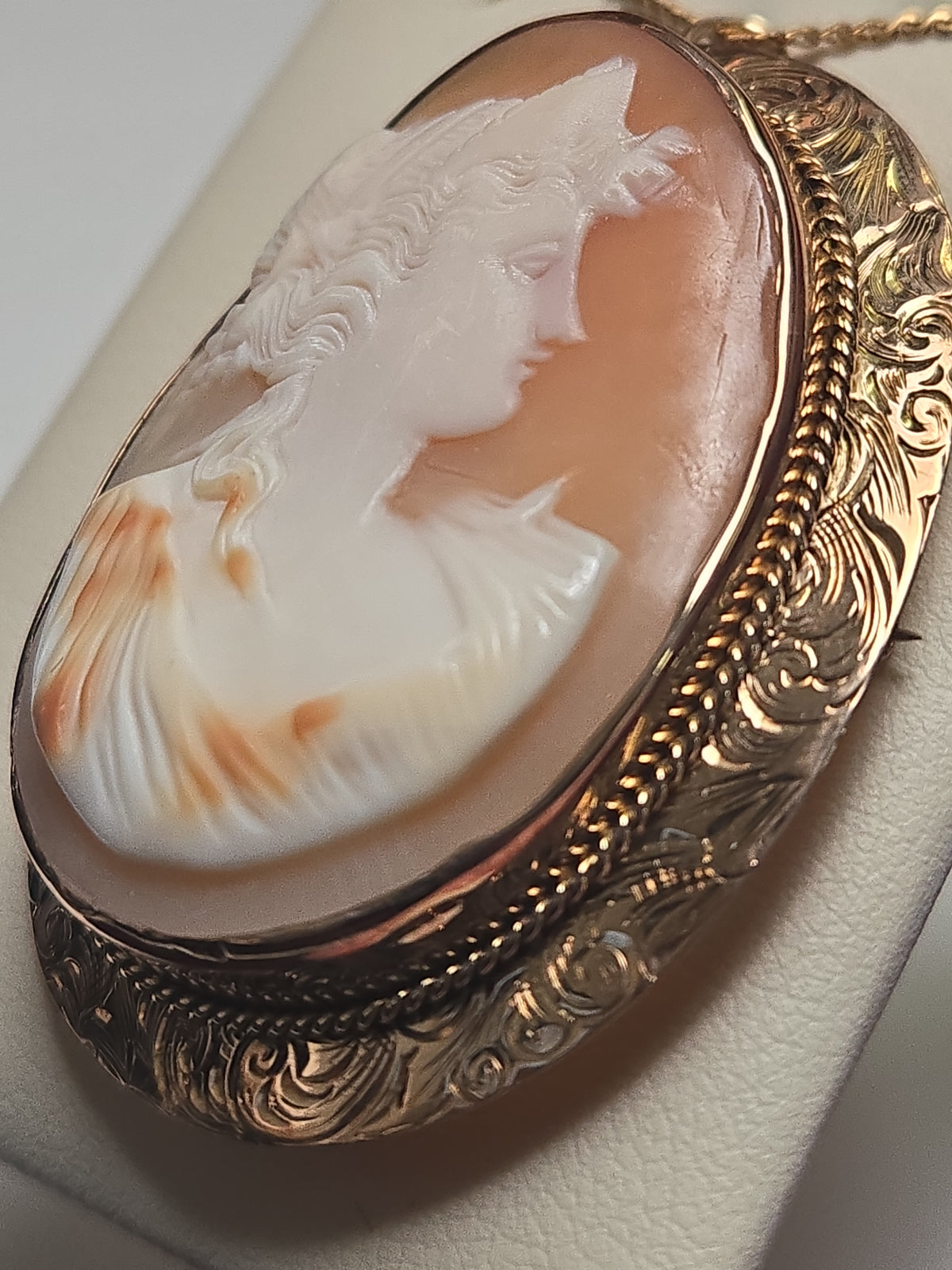 14K gold cameo brooch pendant with detailed carved design, weighing 10g, by Chique Jewelry, shown in close-up detail.