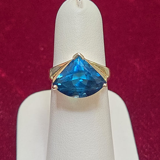 14K gold-colored stone ring featuring a trillion-cut blue topaz gemstone, from Chique Jewelry.