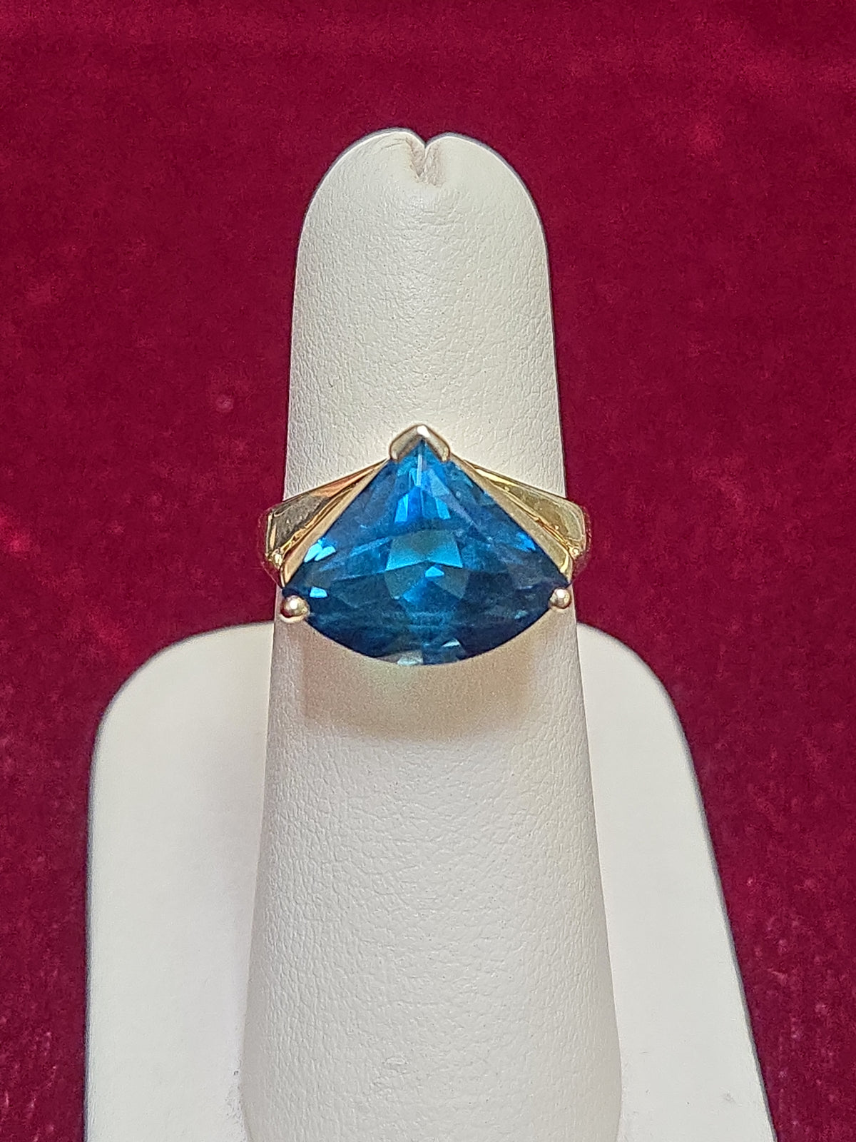14K gold-colored stone ring featuring a trillion-cut blue topaz gemstone, from Chique Jewelry.