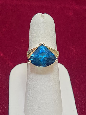 14K gold-colored stone ring featuring a trillion-cut blue topaz gemstone, from Chique Jewelry.