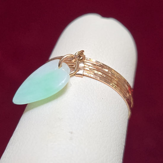 14K rose gold charm ring with a pear-shaped jade gemstone, weighing 1.1 grams, by Chique Jewelry.