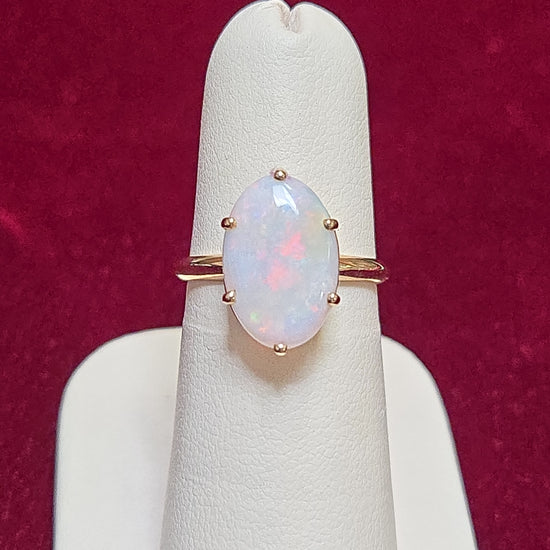 10K gold ring featuring an oval opal gemstone, weighing 2.4 grams, crafted by Chique Jewelry.