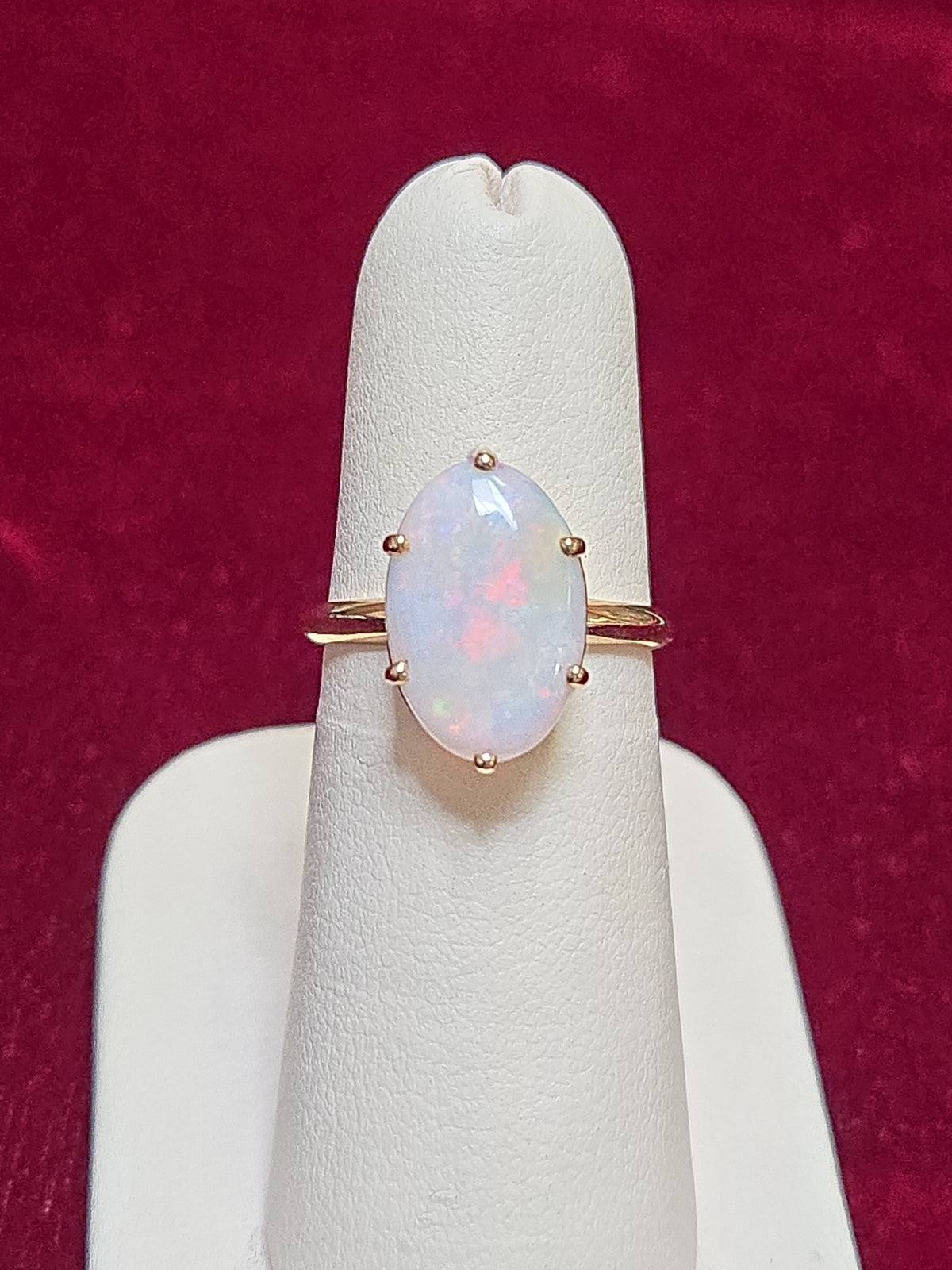10K gold ring featuring an oval opal gemstone, weighing 2.4 grams, crafted by Chique Jewelry.