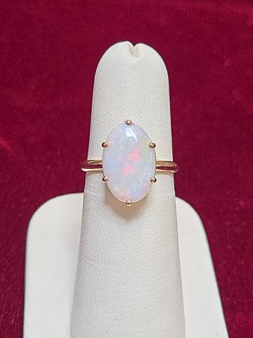 10K gold ring featuring an oval opal gemstone, weighing 2.4 grams, crafted by Chique Jewelry.