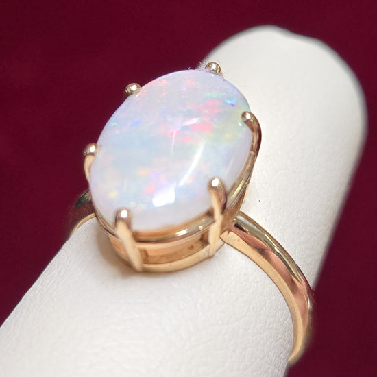 10K gold ring with oval opal gemstone, weighing 2.4 grams, by Chique Jewelry, featuring a polished and elegant design.