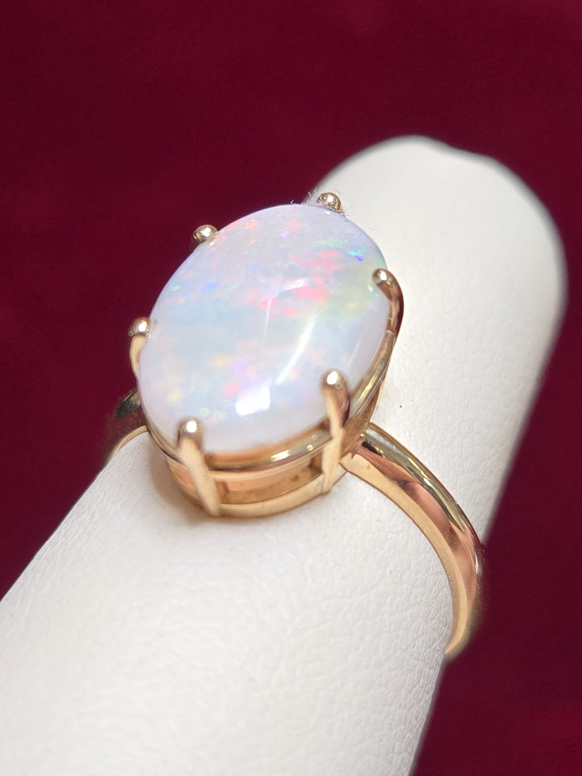 10K gold ring with oval opal gemstone, weighing 2.4 grams, by Chique Jewelry, featuring a polished and elegant design.